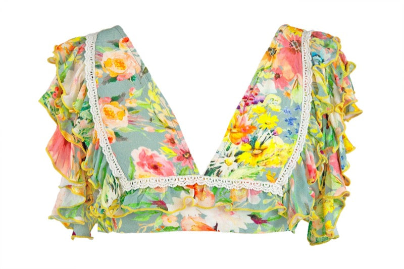 TROPICAL VINTAGE FLORAL PRINTED FLUTTER SLEEVE CROP TOP WITH DELICATE CROCHET TRIM ACROSS THE BODICE AND TIE BACK BOW DETAIL AT THE BACK.